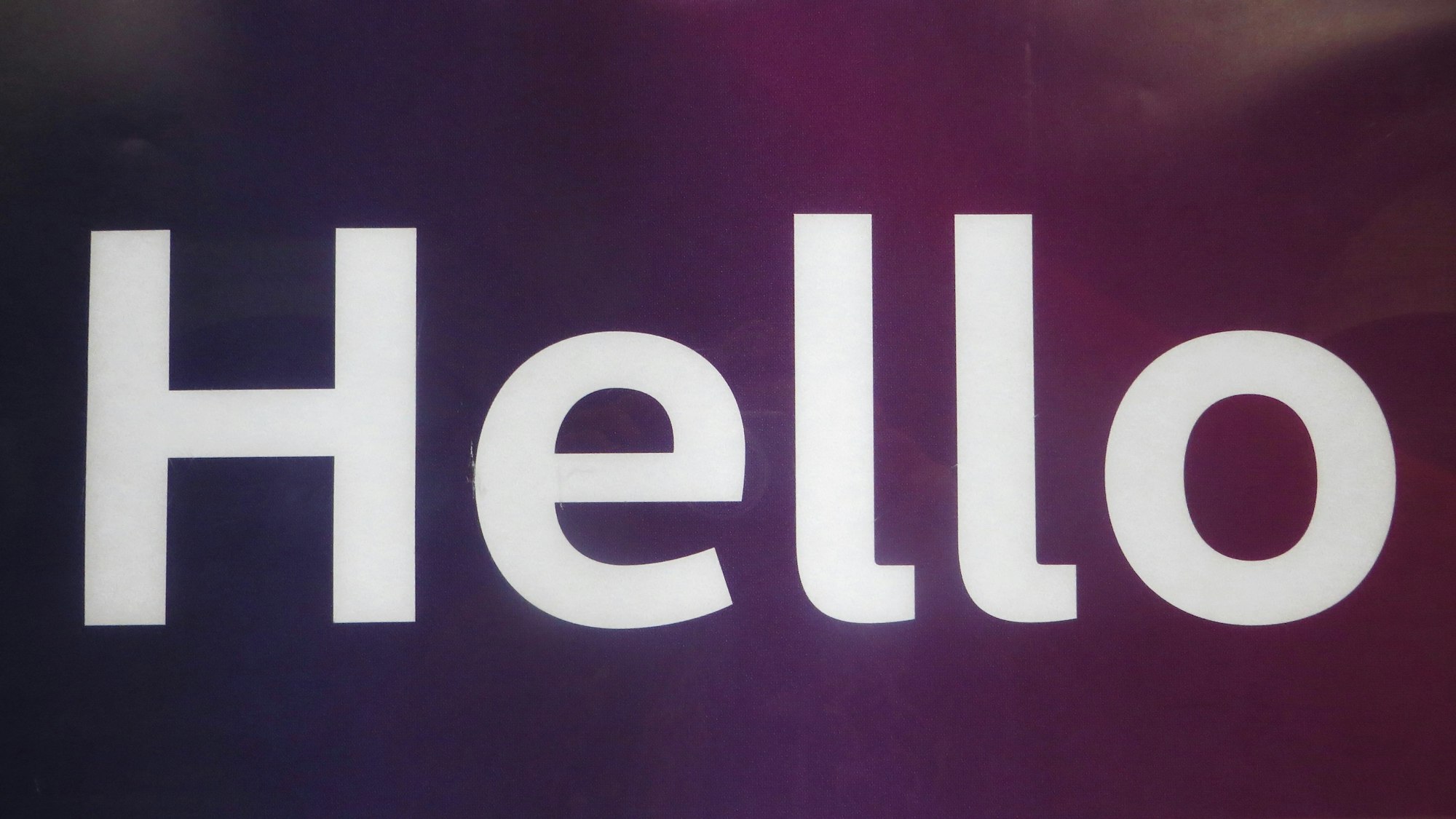 Hello in large white letters on a dark purple background